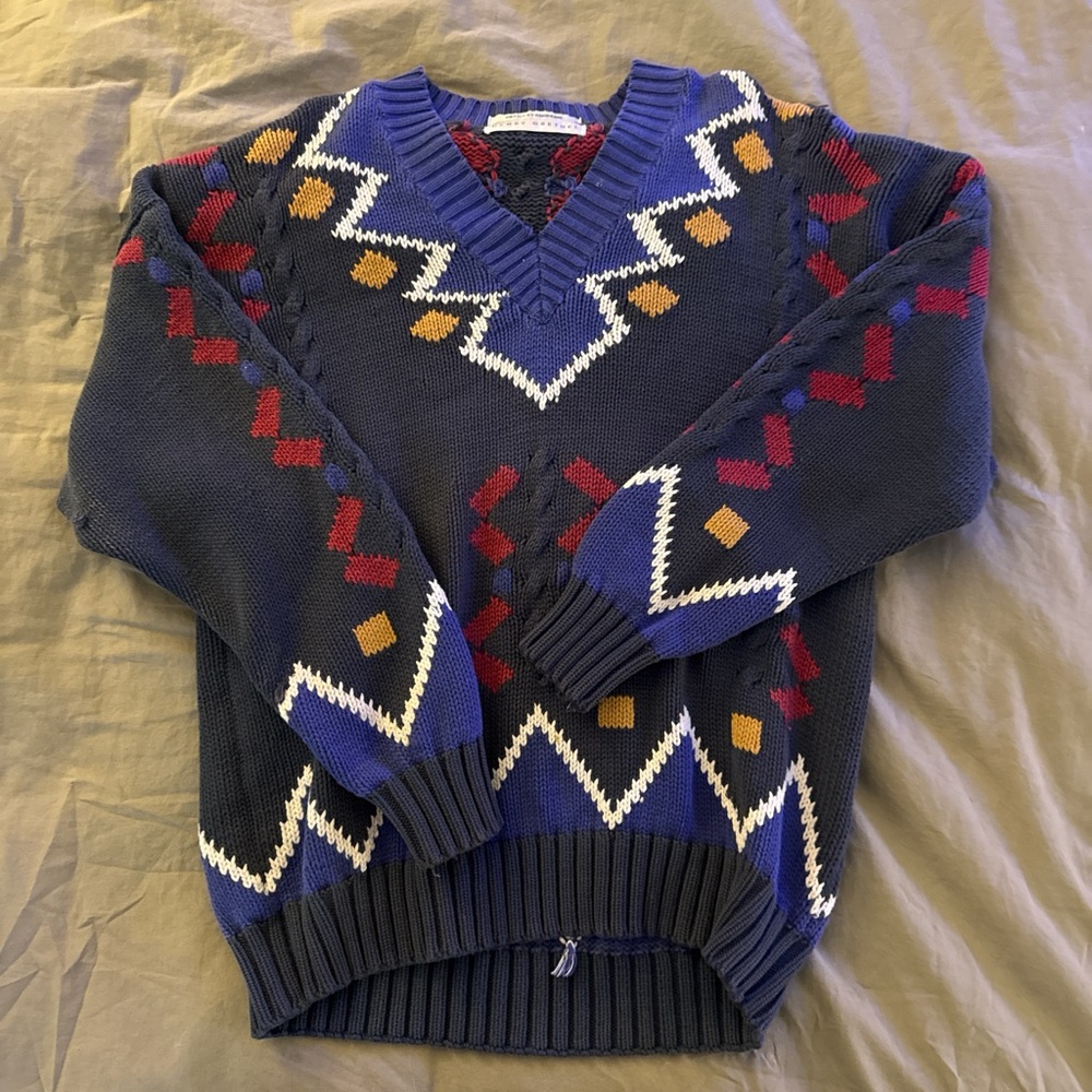 Bold Blue and Red V-Neck Sweater with Geometric Patterns